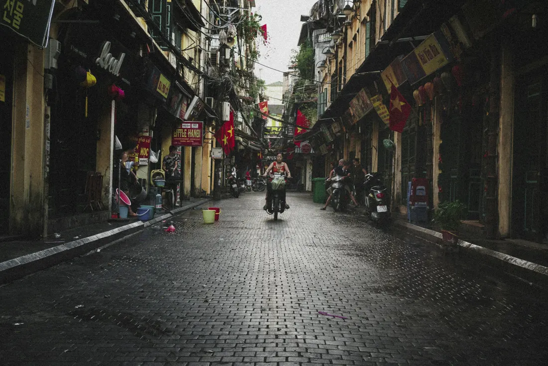 A cobbled lane hung with flags